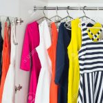 45513018-a-series-of-bright-modern-fashion-women-s-dresses-on-hangers-in-a-white-cupboard-for-summer-and-spri